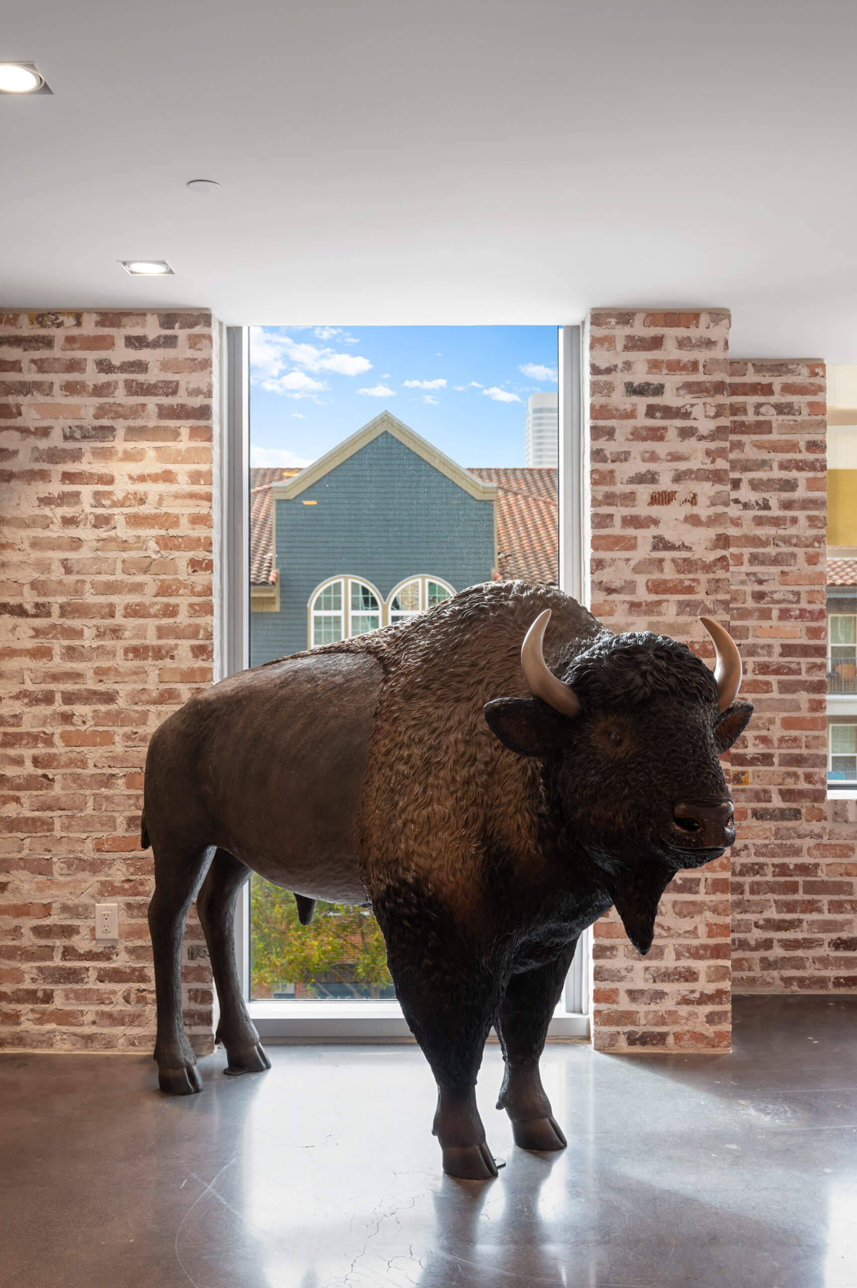 Life-size bison figure in front of a window at St. Andrie.